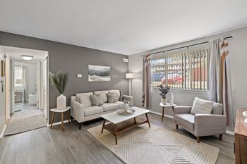 A living room with couches and chairs and a table